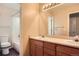 Bathroom with a dual sink vanity, ample counter space and well-lit mirror, plus a shower-tub combo at 560 Hampstead Ave, Castle Rock, CO 80104