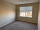 Spacious bedroom with neutral walls and carpet, featuring a window with blinds at 560 Hampstead Ave, Castle Rock, CO 80104