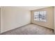 Bright bedroom featuring neutral paint and carpet, with a window offering neighborhood views at 560 Hampstead Ave, Castle Rock, CO 80104