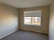 Well-lit bedroom with neutral walls, carpet, and a window with blinds at 560 Hampstead Ave, Castle Rock, CO 80104