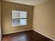 Simple bedroom with hardwood floors and a window with blinds at 560 Hampstead Ave, Castle Rock, CO 80104