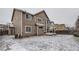 Back exterior featuring a multi-story house with a deck, bay window, and snow-covered backyard at 560 Hampstead Ave, Castle Rock, CO 80104