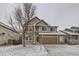 Charming two-story home with a well-maintained lawn and attached garage and beautiful snow covered front yard at 560 Hampstead Ave, Castle Rock, CO 80104