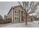 Charming two-story home with an attached garage and snow covered front yard at 560 Hampstead Ave, Castle Rock, CO 80104