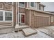 Inviting front entrance with red door, brick accents, and a covered porch at 560 Hampstead Ave, Castle Rock, CO 80104