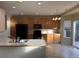 Kitchen with light wood cabinets, black appliances, and a breakfast bar at 560 Hampstead Ave, Castle Rock, CO 80104