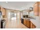 Eat-in kitchen features wood cabinets, an island, and plenty of natural light at 560 Hampstead Ave, Castle Rock, CO 80104