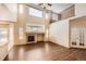 Bright and airy living room with hardwood floors, large window, and a fireplace at 560 Hampstead Ave, Castle Rock, CO 80104