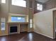 Two-story living room with a fireplace and hardwood floors at 560 Hampstead Ave, Castle Rock, CO 80104