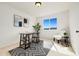 This home office is bright and functional, with a desk, chair, and a serene view outside at 6232 W Cross Dr, Littleton, CO 80123