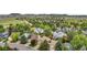 Aerial view of a neighborhood with lush green trees and mountain views at 4707 N Bearlily Way, Castle Rock, CO 80109