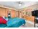 Cozy bedroom with light carpet, wood-framed mirror, and large dresser with decorative vanity at 4707 N Bearlily Way, Castle Rock, CO 80109