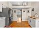 View of hardwood floors and stainless steel refrigerator and into the dining area at 4707 N Bearlily Way, Castle Rock, CO 80109