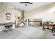 Spacious living room with neutral carpet, modern ceiling fan, and open staircase to the second level at 4707 N Bearlily Way, Castle Rock, CO 80109