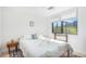 Bright bedroom with white walls, light hardwood floors, and a large window providing ample natural light at 180 Cook St # 406, Denver, CO 80206