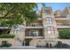 Multi-story condo building, 'The Catalonian', with balconies and decorative landscaping at 180 Cook St # 406, Denver, CO 80206