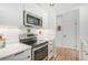 Well-equipped kitchen with stainless steel appliances and modern white cabinetry at 180 Cook St # 406, Denver, CO 80206