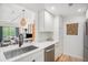 Bright, modern kitchen featuring stainless steel appliances and a view of the living room at 180 Cook St # 406, Denver, CO 80206