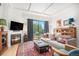 Comfortable living room featuring a cozy fireplace, stylish furnishings, and access to the outdoor balcony at 180 Cook St # 406, Denver, CO 80206