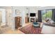 Inviting living room with hardwood floors, fireplace, and a sliding glass door to a balcony at 180 Cook St # 406, Denver, CO 80206