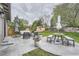Spacious backyard with a concrete patio, outdoor seating, manicured lawn, and privacy fence at 1641 S Parfet Ct, Denver, CO 80232