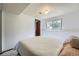 Bedroom with neutral walls, large bed, and a window providing natural light at 1641 S Parfet Ct, Denver, CO 80232