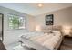 Comfortable bedroom features a large window, neutral walls, and a stylish headboard at 1641 S Parfet Ct, Denver, CO 80232