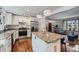Bright kitchen features stainless appliances, granite countertops, white cabinetry, and an island at 1641 S Parfet Ct, Denver, CO 80232