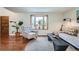 Cozy living room with natural light, hardwood floors, comfortable seating, and stylish decor at 1641 S Parfet Ct, Denver, CO 80232
