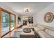 Bright living room with hardwood floors, sliding doors to backyard, and open access to the kitchen at 1641 S Parfet Ct, Denver, CO 80232