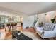Open living space showcasing hardwood floors, a staircase, and a glimpse into the adjacent kitchen at 1641 S Parfet Ct, Denver, CO 80232