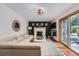 Cozy living room features a white brick fireplace, a mounted TV, and sliding doors to the backyard at 1641 S Parfet Ct, Denver, CO 80232