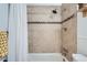 Shower featuring tan tile with decorative tile accents, and chrome shower head at 1641 S Parfet Ct, Denver, CO 80232