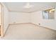 Basement room featuring carpeted floors, ample natural light from the window, and neutral colored walls at 3231 Oak St, Wheat Ridge, CO 80033