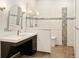 Modern bathroom featuring a glass-enclosed shower and vanity with stylish fixtures and a tile backsplash at 3231 Oak St, Wheat Ridge, CO 80033