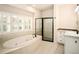 Elegant bathroom featuring a soaking tub, shower, and vanity with updated fixtures and finishes at 3231 Oak St, Wheat Ridge, CO 80033