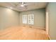 Spacious bedroom with a tray ceiling, hardwood floors, and ample natural light from two large windows at 3231 Oak St, Wheat Ridge, CO 80033