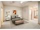 Elegant bedroom with a tray ceiling, plantation shutters, and access to the ensuite bathroom at 3231 Oak St, Wheat Ridge, CO 80033