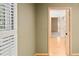 View into a bedroom with a closet and wood flooring featuring plantation shutters for natural light at 3231 Oak St, Wheat Ridge, CO 80033