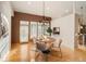 Dining room with hardwood floors, modern chandelier, and views to the kitchen at 3231 Oak St, Wheat Ridge, CO 80033
