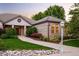 Beautiful single-Gathering home with manicured lawn and landscaped beds at 3231 Oak St, Wheat Ridge, CO 80033