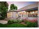 Rear exterior featuring patio, well-maintained landscaping and brickwork at 3231 Oak St, Wheat Ridge, CO 80033