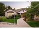 Exterior of home with stonework details, meticulous landscaping and brick walkway to front door at 3231 Oak St, Wheat Ridge, CO 80033