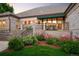 View of brick home exterior with awning, patio, and landscaped yard at 3231 Oak St, Wheat Ridge, CO 80033