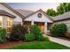 Exterior shot of home with manicured landscaping and walkway to front door with portico at 3231 Oak St, Wheat Ridge, CO 80033