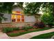 Charming home with large windows allowing natural light, complemented by beautiful landscaping and green lawn at 3231 Oak St, Wheat Ridge, CO 80033