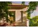 Exterior shot of a stucco home with stonework, a gated driveway and window with blinds at 3231 Oak St, Wheat Ridge, CO 80033