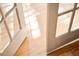 Sunlight streams through open French doors onto gleaming hardwood floors, offering an inviting transition between spaces at 3231 Oak St, Wheat Ridge, CO 80033