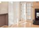A well-lit room featuring elegant French doors and a cozy fireplace with decorative mantle and hearth at 3231 Oak St, Wheat Ridge, CO 80033
