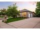 Attractive brick home with a three-car garage, well-kept lawn, and mature landscaping at 3231 Oak St, Wheat Ridge, CO 80033